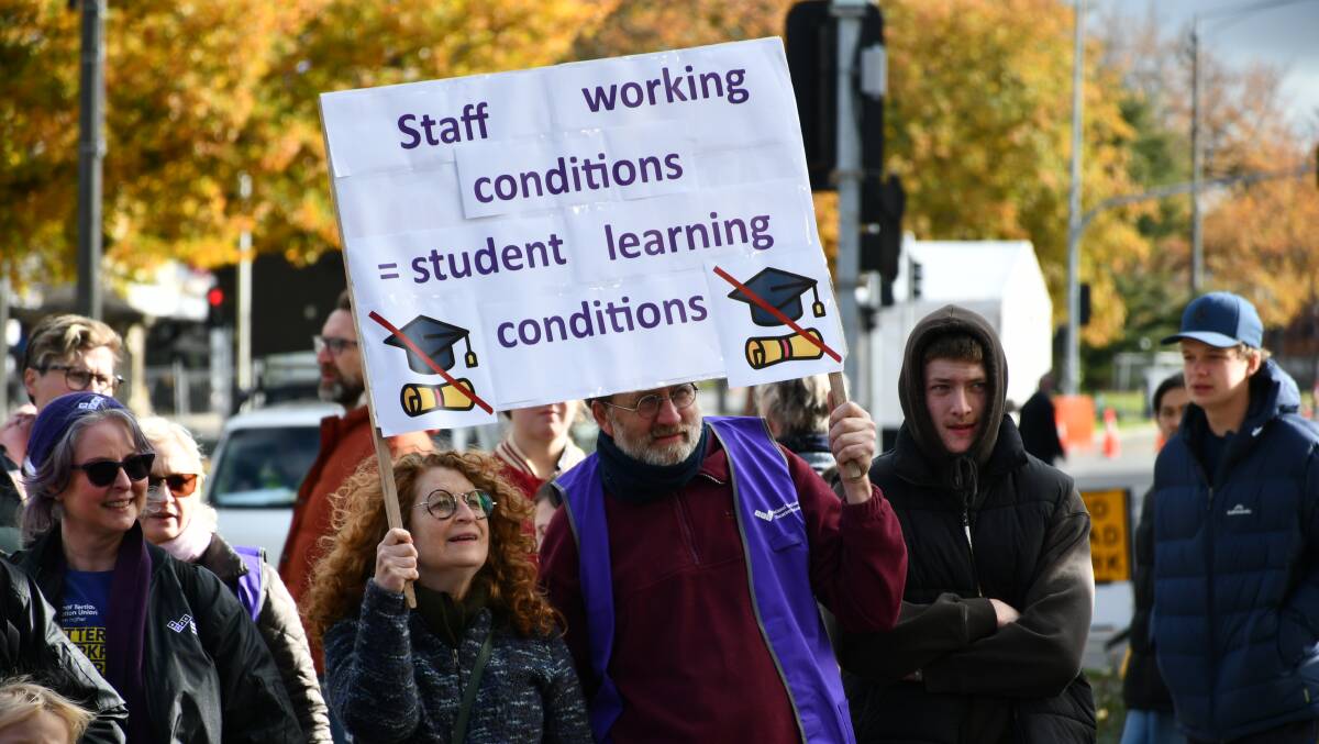 Demonstrators holding a sign at the NTEU rally on Sturt Street, June 1. Picture by Alex Dalziel